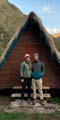 happy couple in love, standing in the doorway of the andean huts