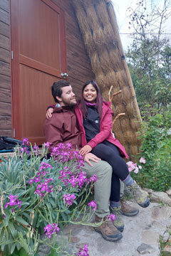 couple in love sitting at the door of the andean huts