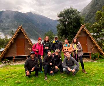 group of tourists trekking in the andean huts