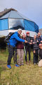 group of happy tourists with a guide at the mountain sky views